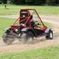 Gemini Red Buggy from side on dirt track